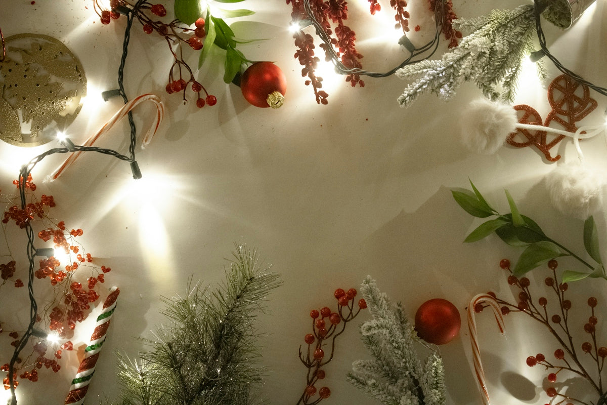 a white table topped with christmas decorations and lights
